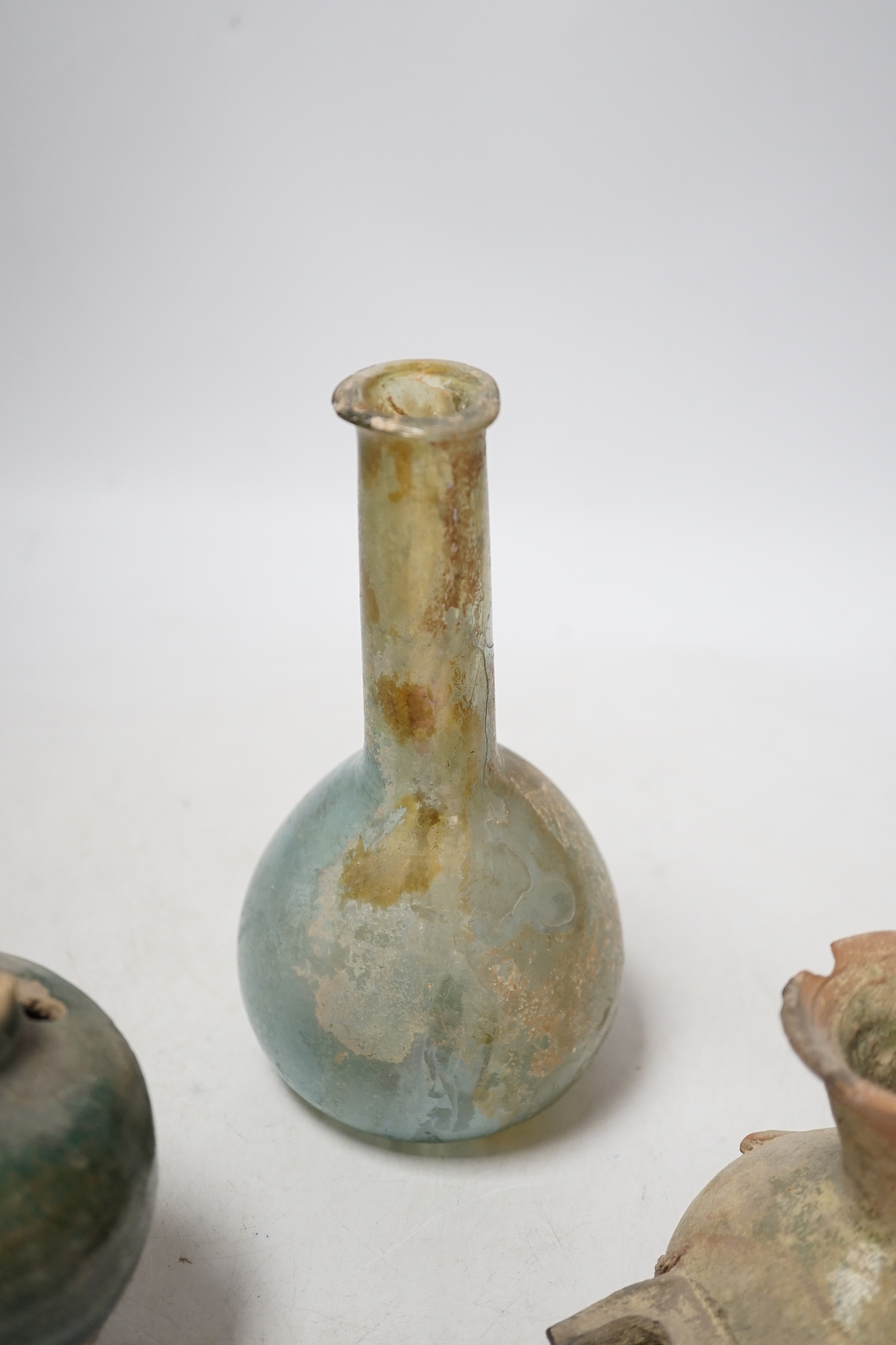 A Roman glass vessel, an Islamic pot and oil lamp, largest 18cm high (3)